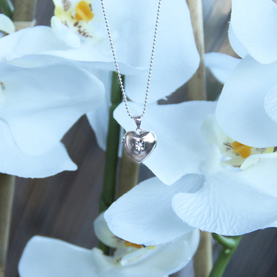 Silver heart necklace with a sparling CZ on a delicate ball chain.