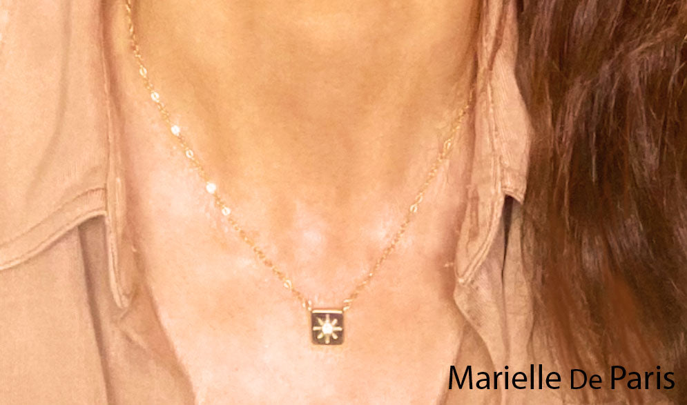 Square 14k yellow Gold Diamond necklace named Soleil. It means Sunshine in English . Pronounce  { So-layll} . The square Gold pendant is adorned with a  0.06ct natural Diamond in the center surrounded with sunrays. it symbolize the light shining in you no matter what.